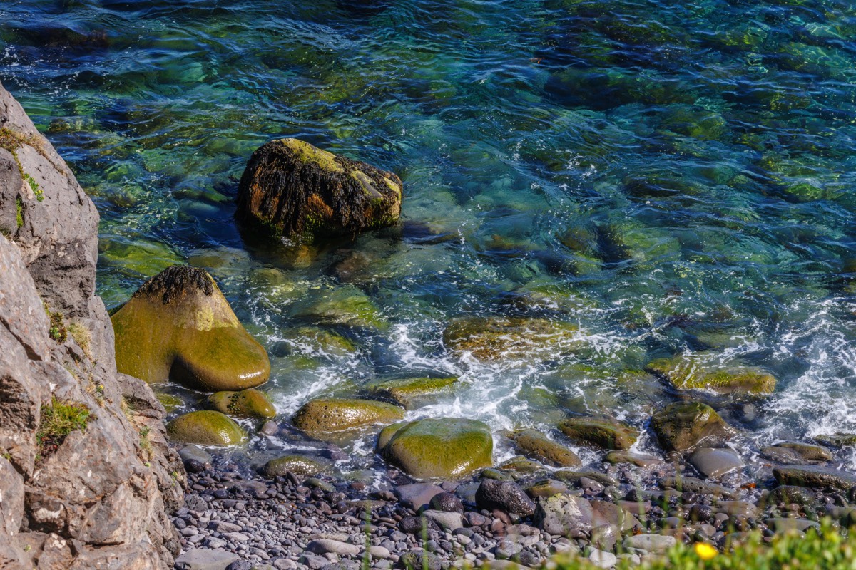 Blue water and green stones